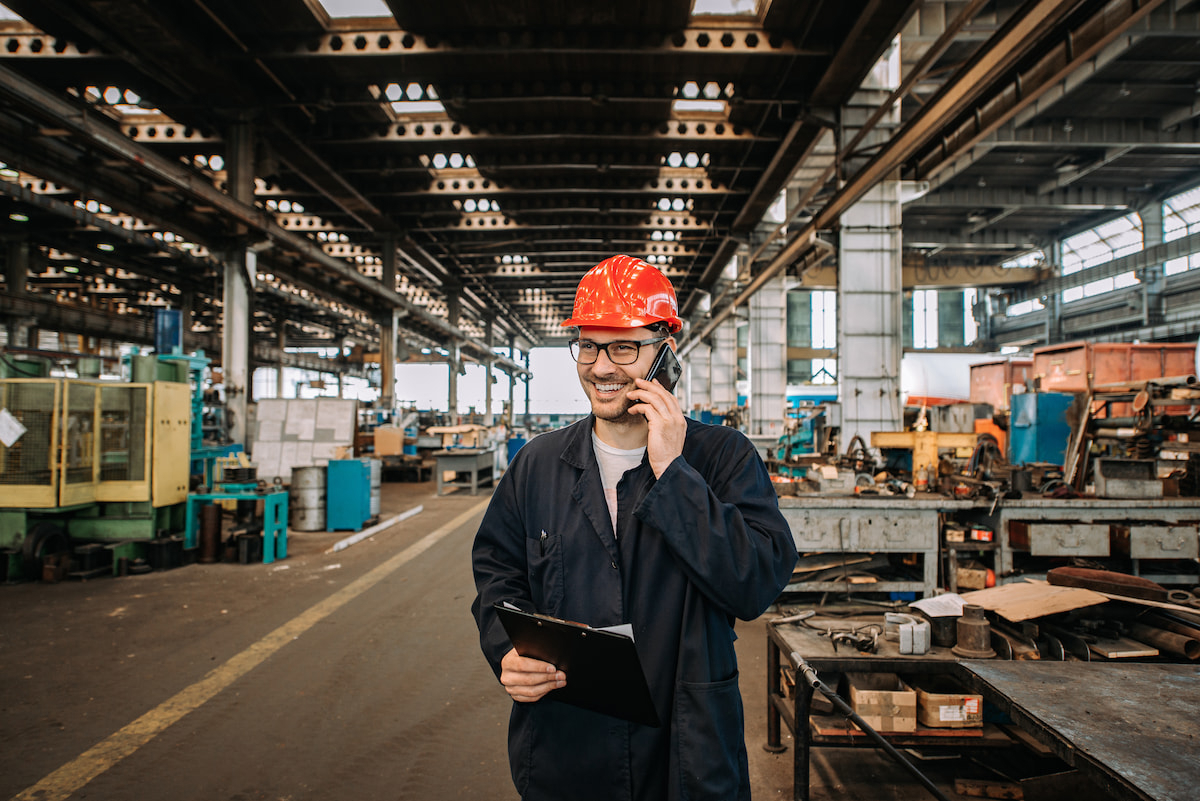 Person on a phone in a manufacturing plant