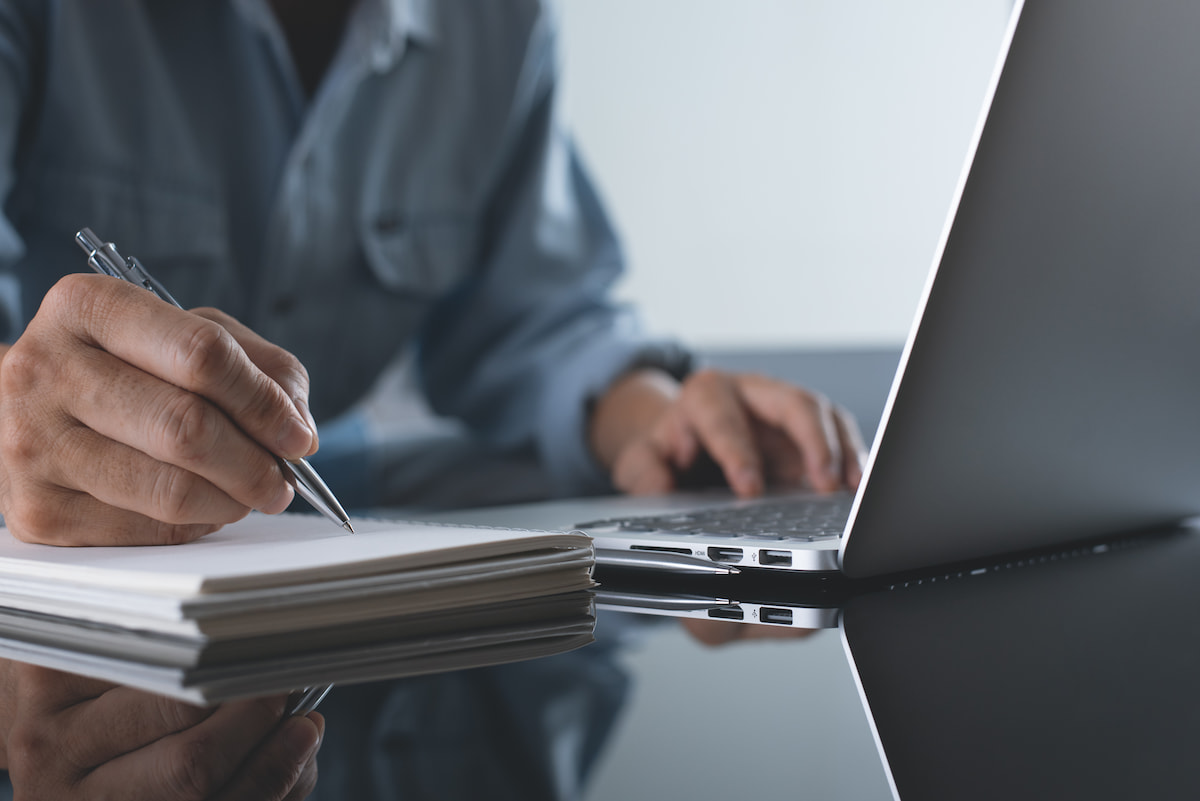 Person taking notes at a computer