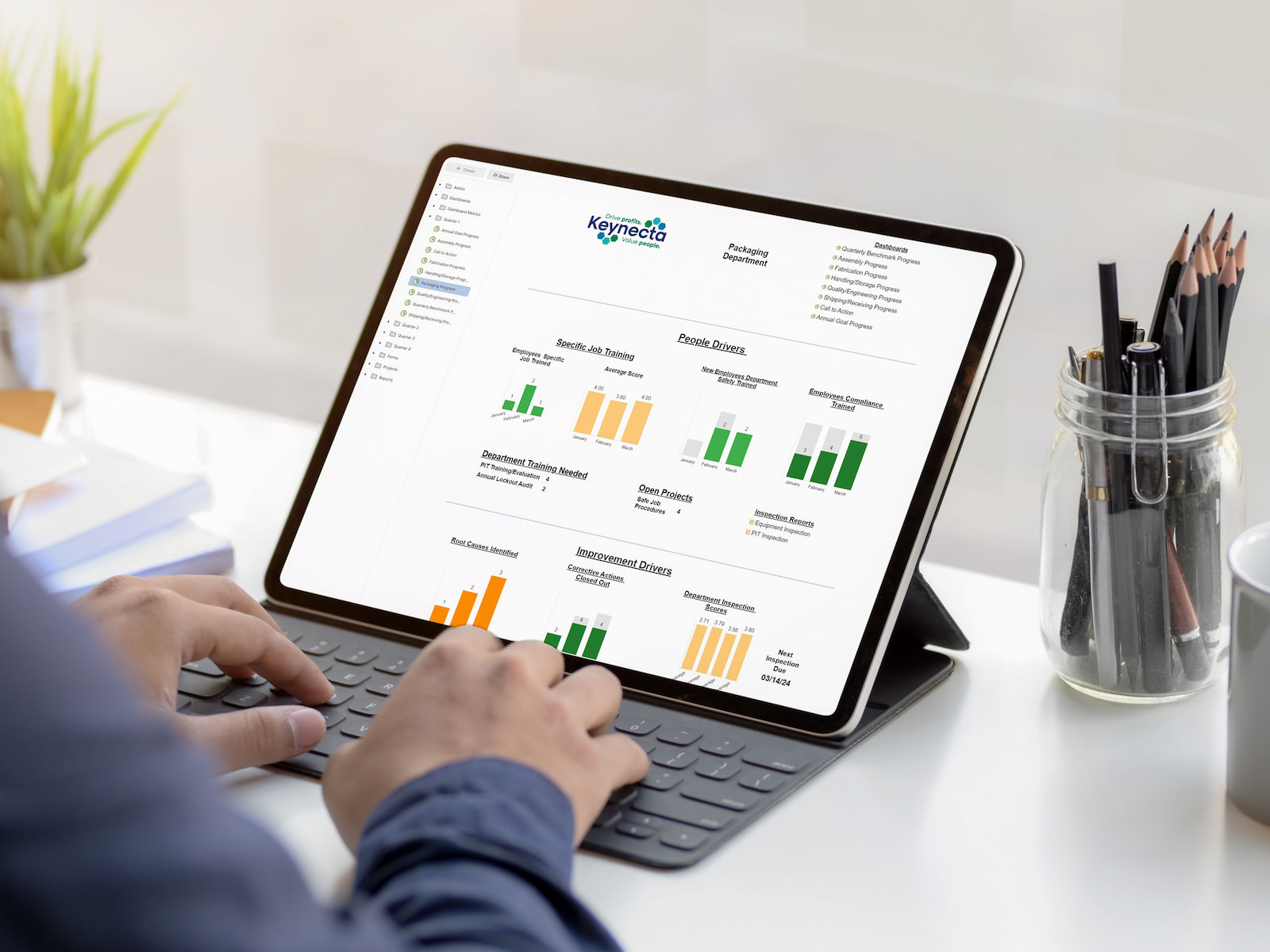 Person working on a tablet with Keynects safety metrics on a screen