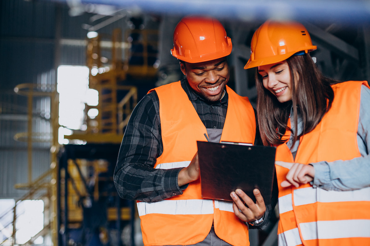 Two people reviewing paperwork on clipboard