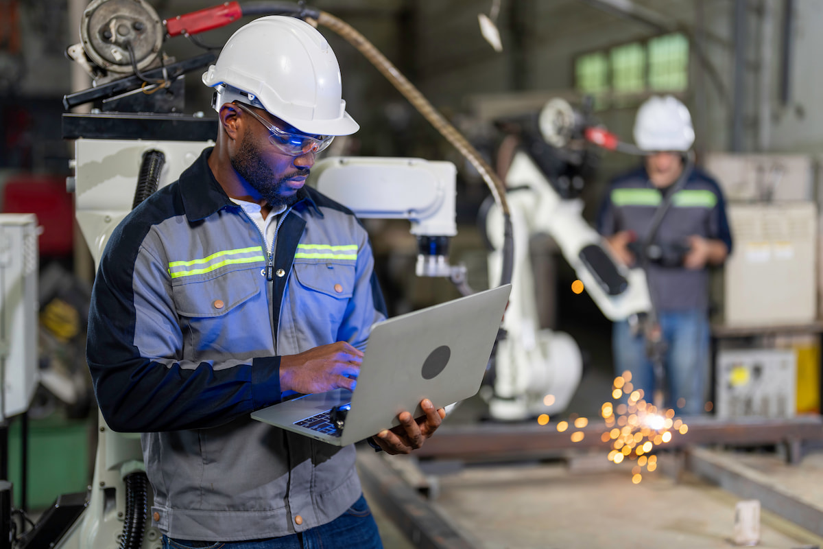 Worker on a computer in a manufacturing plant